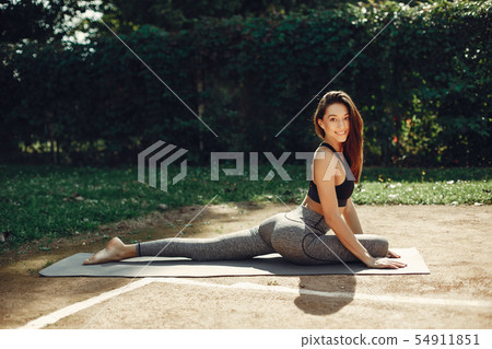 Beautiful sports girl in a summer park Beautiful sports girl in a summer park 54911851