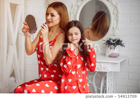 Cute mother and daughter at home in a pajamas Cute mother and daughter at home in a pajamas 54913709