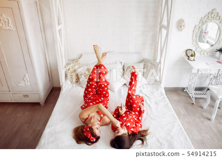 Cute mother and daughter at home in a pajamas 54914215