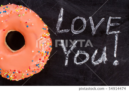 Orange donut and inscription I love you on chalk board. 54914474