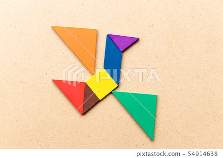 Color tangram puzzle in flying bird shape on wood Color tangram puzzle in flying bird shape on wood 54914638