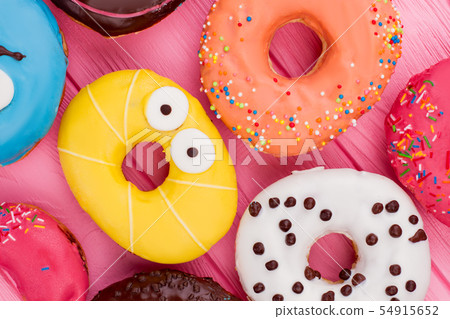Assorted iced donuts background. 54915652