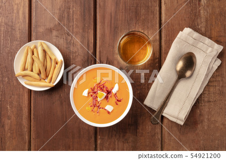 Salmorejo, Spanish cold tomato soup, top shot on a rustic background with wine and picos Salmorejo, Spanish cold tomato soup, top shot on a rustic background with wine and picos 54921200