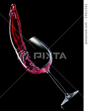 Glass for red wine with splashes isolated on black background. Glass for red wine with splashes isolated on black background. 54921541