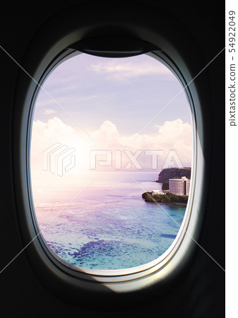 Scenery looking at the eyes of a child from a window in an airplane 54922049