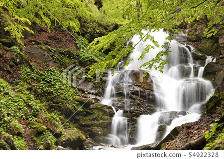 Powerful waterfall on the mountain river. Powerful waterfall on the mountain river. 54922328
