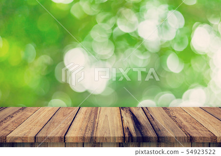 Empty wooden table and abstract blurred green Empty wooden table and abstract blurred green 54923522