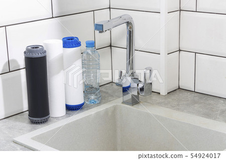 Water filter cartridge in the kitchen. Drinking 54924017
