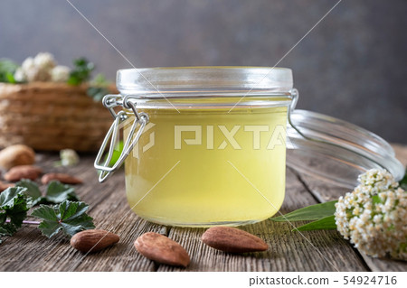 Almond oil in which herbs have been macerated Almond oil in which herbs have been macerated 54924716