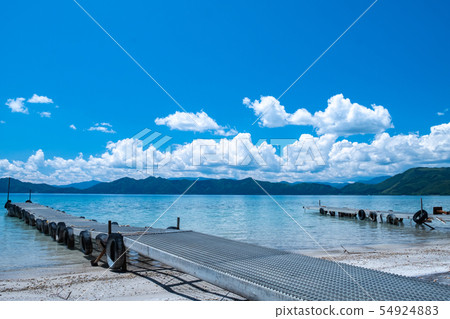 Exhilarating summer blue sky and lake boat landing Exhilarating summer blue sky and lake boat landing 54924883