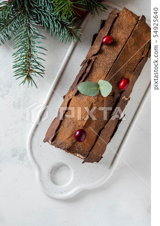 Bush de Noel Christmas Log Cake and New Year background. Copy space. Bush de Noel Christmas Log Cake and New Year background. Copy space. 54925640