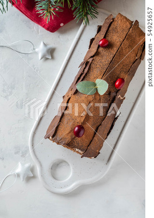 Bush de Noel Christmas Log Cake and New Year background. Copy space. Bush de Noel Christmas Log Cake and New Year background. Copy space. 54925657