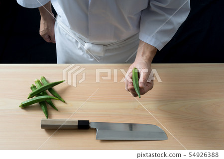 Board front holding okra in hand 54926388