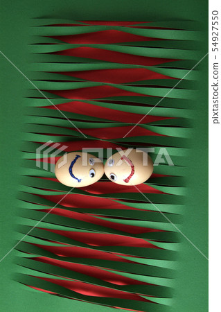 Eggs with eyes isolated on striped green paper 54927550