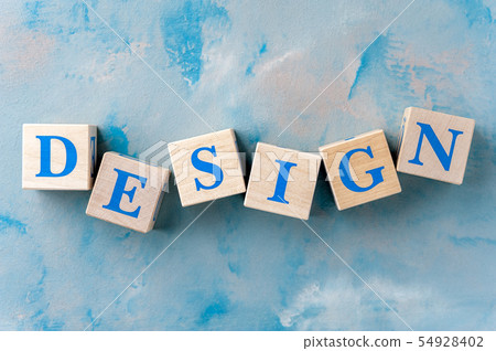 Wooden cubes with word DESIGN on blue table. Wooden cubes with word DESIGN on blue table. 54928402