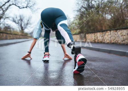 Get better everyday Back view of disabled athlete woman in sportwear with prosthetic leg getting Get better everyday Back view of disabled athlete woman in sportwear with prosthetic leg getting 54928935
