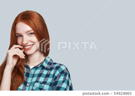 Sunny girl. Modern playful teenage girl touching lips and looking at the camera 54929065