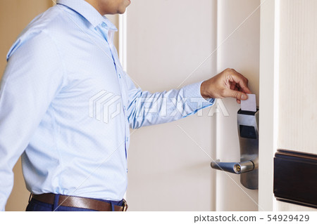 Businessman opening the hotel room Businessman opening the hotel room 54929429