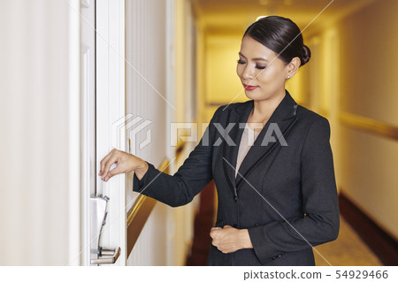 Businesswoman arriving in the hotel Businesswoman arriving in the hotel 54929466