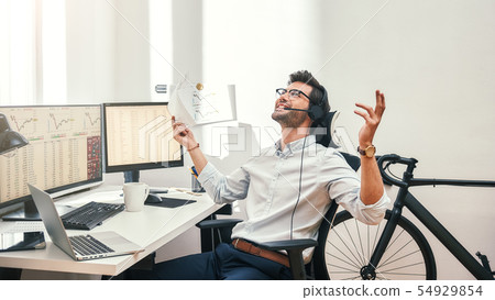 Great Happy and successful bearded trader in headset holding financial report, talking with client Great Happy and successful bearded trader in headset holding financial report, talking with client 54929854