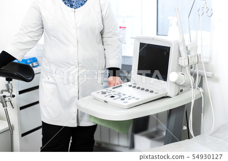 The doctor is preparing to conduct ultrasound The doctor is preparing to conduct ultrasound 54930127