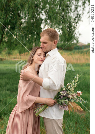Young loving couple hugging and dancing on the Young loving couple hugging and dancing on the 54930231