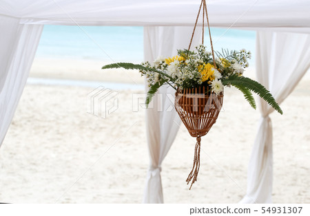 Hanging flower vase decorated at the beach 54931307
