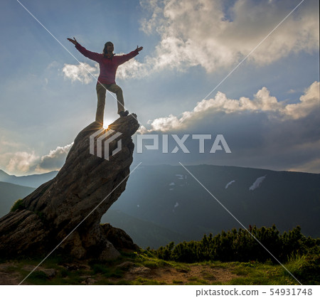 Happy woman on rock 54931748