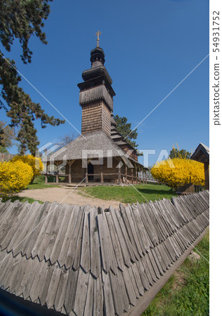 Wooden church among blossom trees Wooden church among blossom trees 54931752