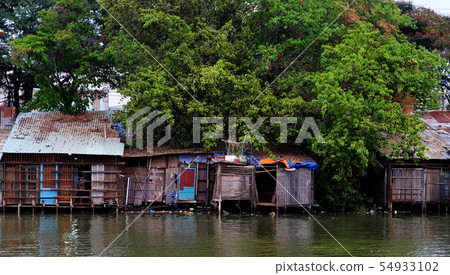 riverside old downgrade house under big tree 54933102