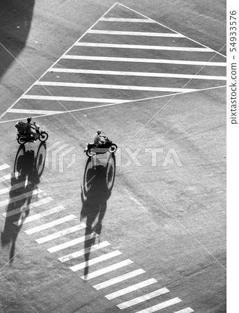 Amazing scene shadow people ride motorbikes on roa 54933576