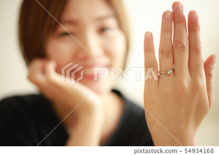 Woman showing a ring 54934168