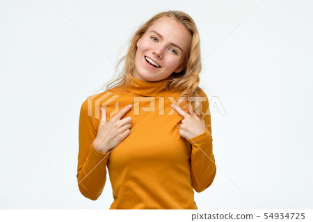 Happy young teenager woman pointing fingers at herself. Happy young teenager woman pointing fingers at herself. 54934725
