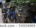 A line of bicycles on the street 54934969