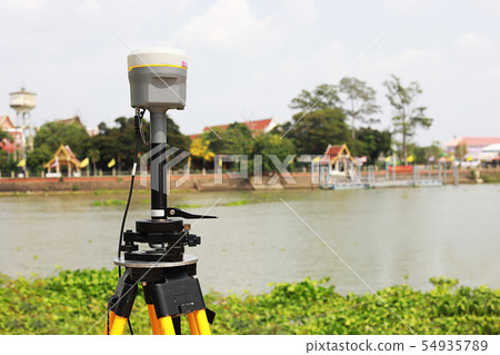 GPS surveying in field sea background, Global GPS surveying in field sea background, Global 54935789