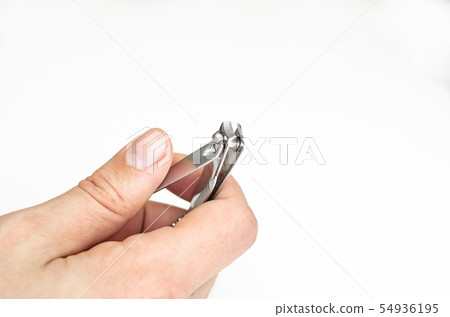 Young man holding a nail clipper tool. Young man holding a nail clipper tool. 54936195