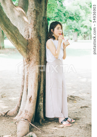 Woman drinking tapioca milk tea 54936903