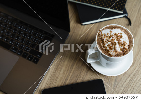 notebooks with laptop  and coffee cup on the desk 54937557