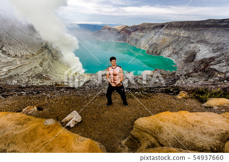 Young man in the crater of a volcano 54937660
