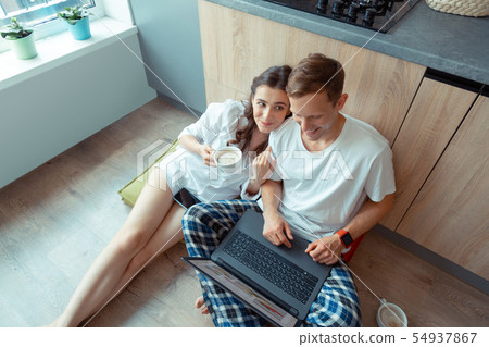 Top view of couple enjoying their morning before going to office Top view of couple enjoying their morning before going to office 54937867