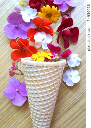 Waffle ice cream cone with flowers Waffle ice cream cone with flowers 54939018