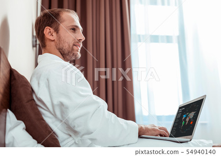 Busy light-haired man checking information on a laptop 54940140