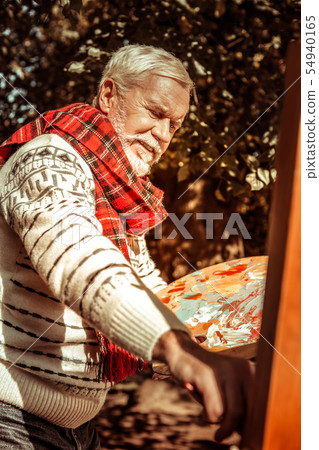 Outdoor painter working on his new picture. Outdoor painter working on his new picture. 54940165