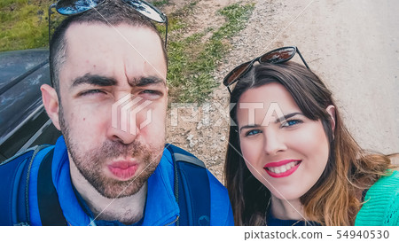 Happy young couple doing silly and funny faces Happy young couple doing silly and funny faces 54940530