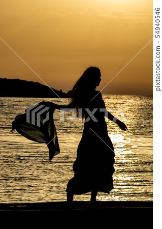 Beautiful silhouette at sunset golden sea water Beautiful silhouette at sunset golden sea water 54940546