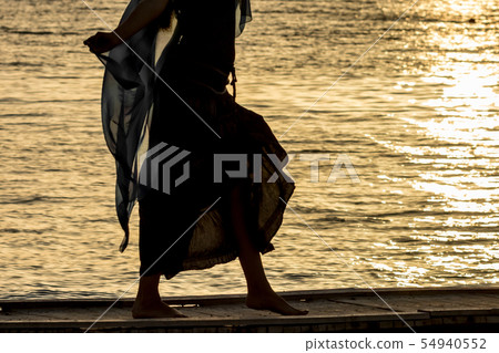 Beautiful silhouette at sunset golden sea water Beautiful silhouette at sunset golden sea water 54940552