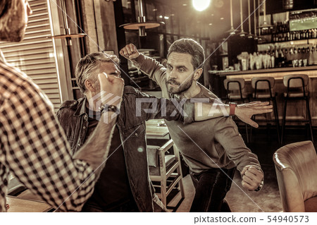 Grey-haired male person trying to stop quarrel Grey-haired male person trying to stop quarrel 54940573