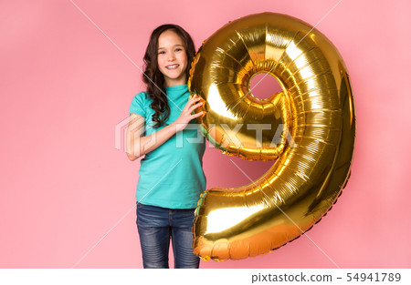 Cute girl with number 9 balloon at studio background 54941789