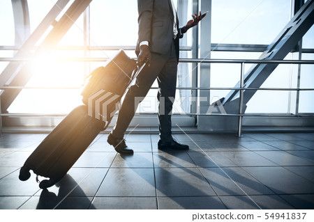Businessman Carrying Baggage, Moving to Boarding Gate 54941837