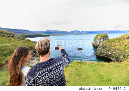 Tourists on travel taking photo on Iceland Tourists on travel taking photo on Iceland 54942642